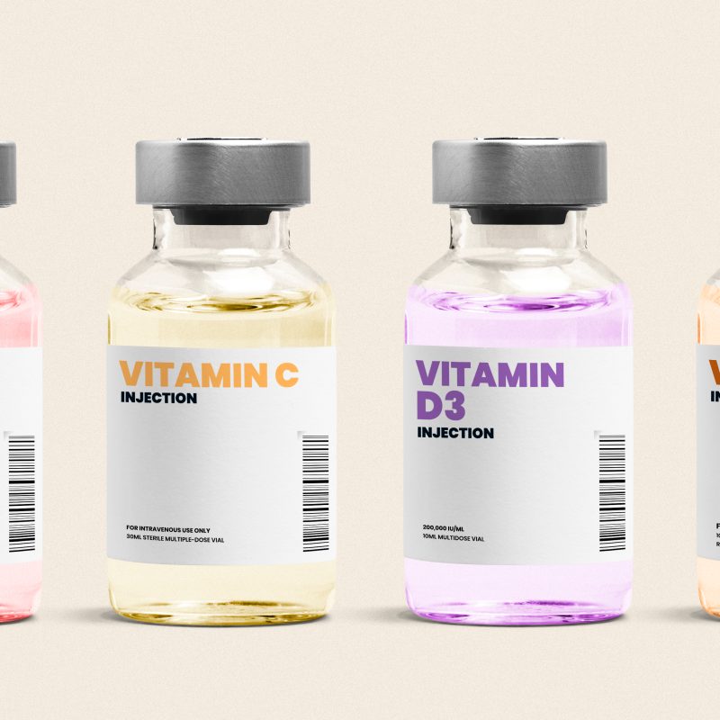 vitamin,injection,glass,bottles,on,beige,background