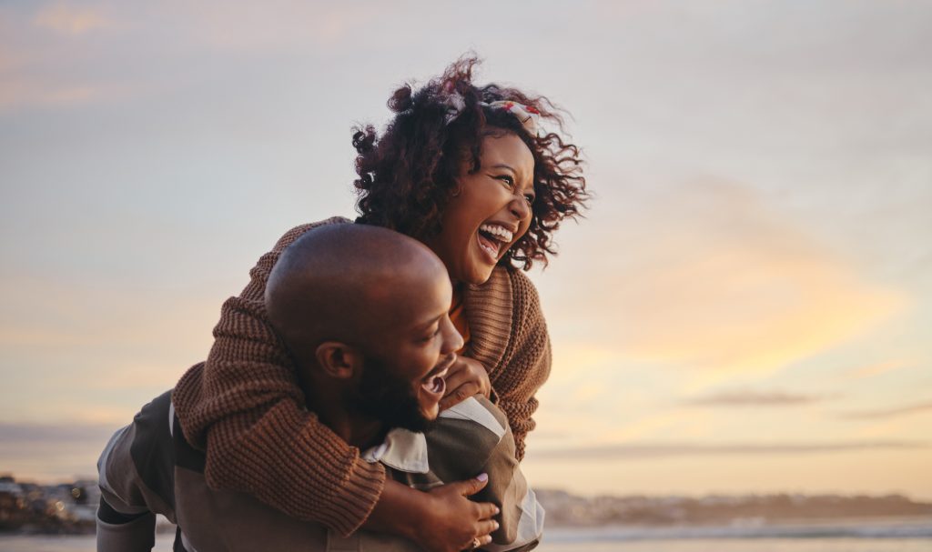 black,couple,,travel,and,beach,fun,while,laughing,on,sunset