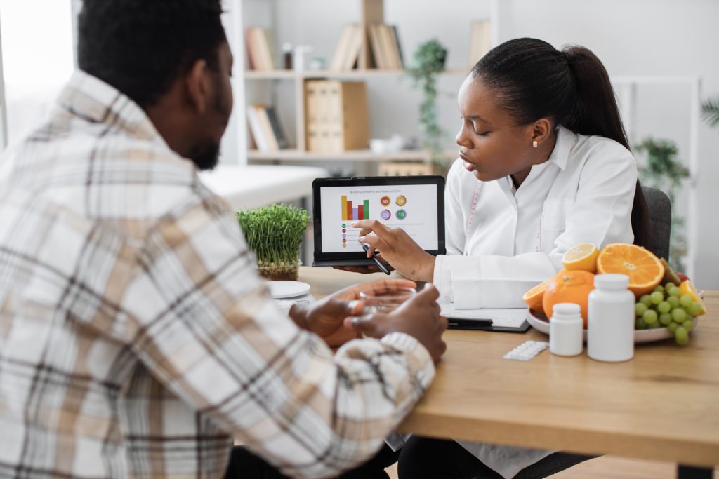 over shoulder,view,of,african,american,woman,analyzing,patient's,nutrition,data